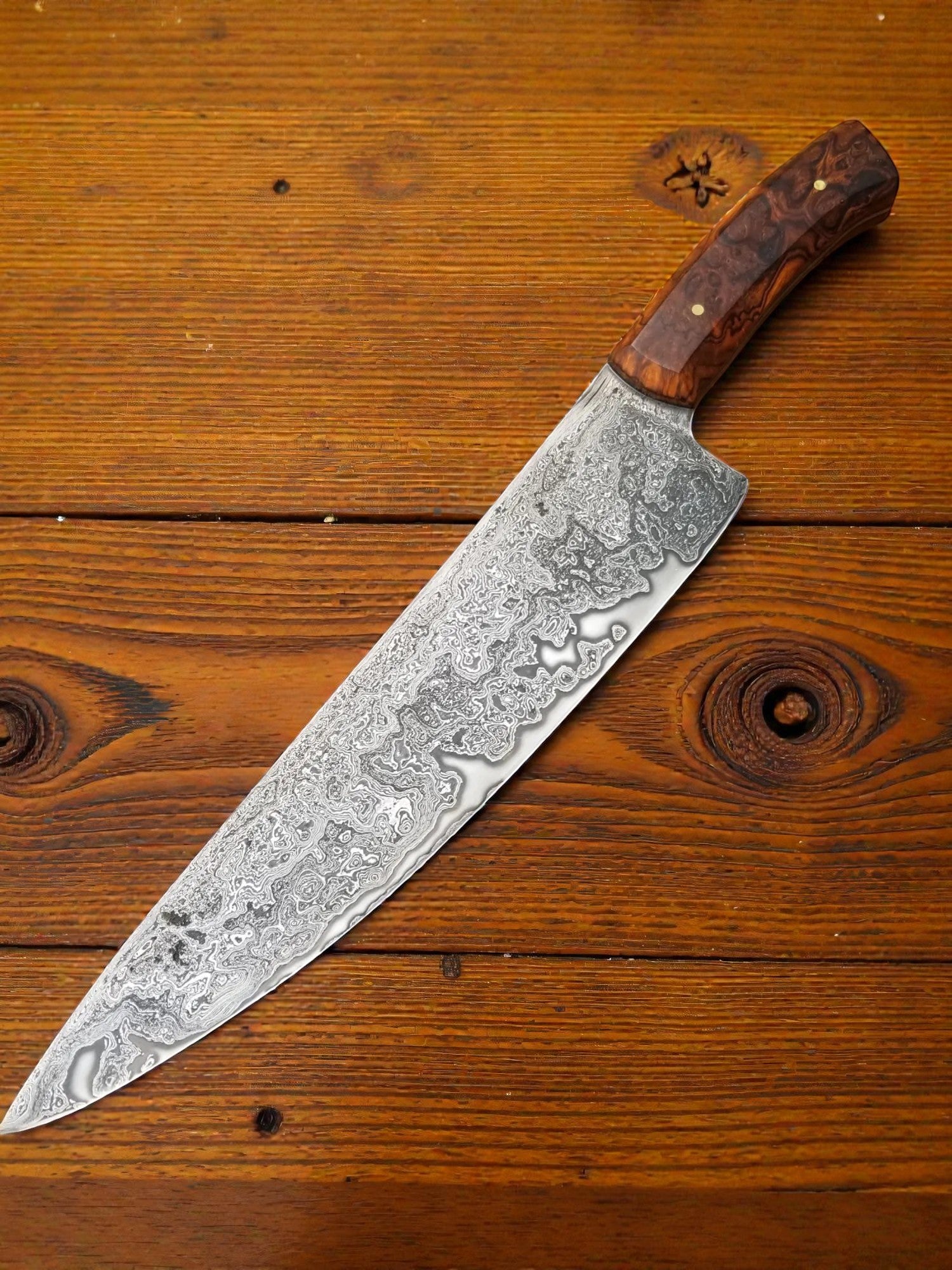 Custom Damascus kitchen knife featuring patterned steel blade and wood handle
