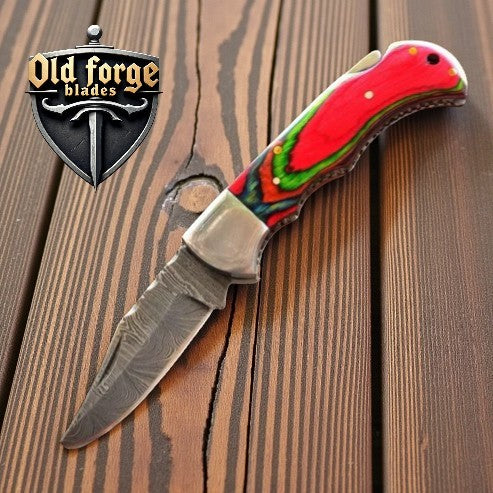 Handcrafted Damascus steel pocket knife with Multi Pakka Wood handle and leather sheath