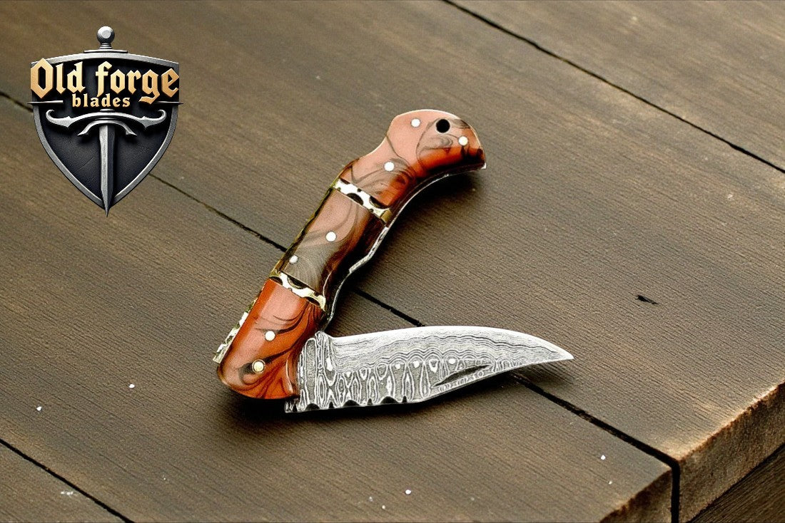 Handmade Damascus pocket knife with epoxy resin handle and leather sheath