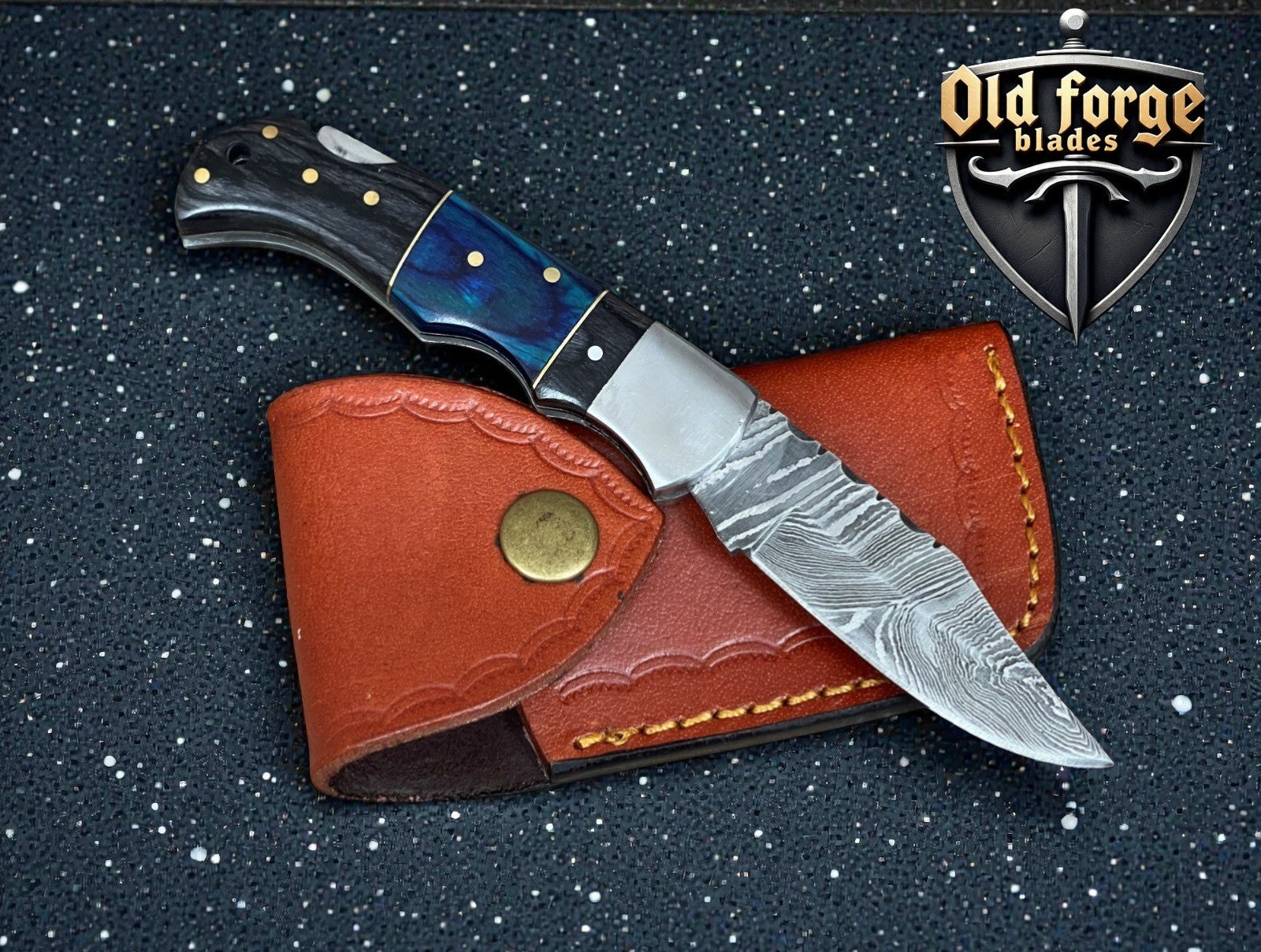 Handcrafted Damascus steel pocket knife with colored wood handle and leather sheath