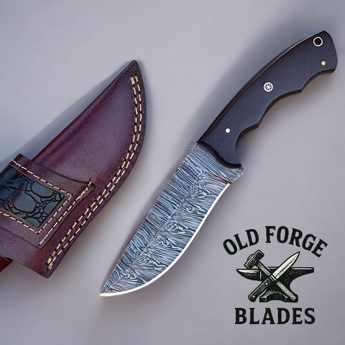 Knife with leather sheath and 'Old Forge Blades' logo on a gray background