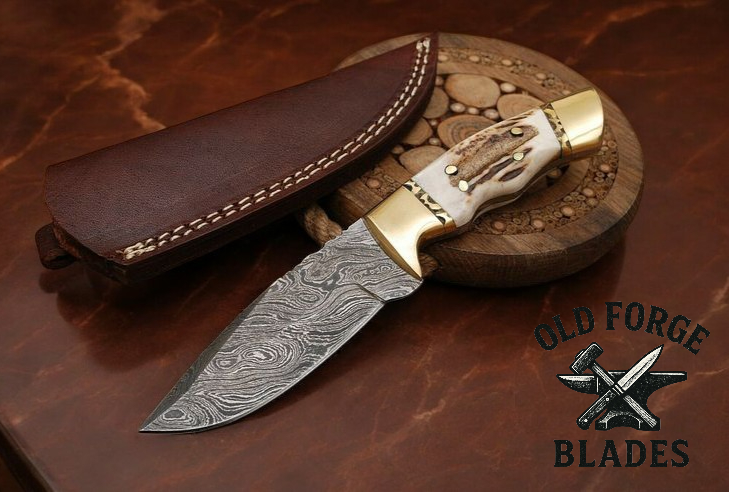 Demascus blade knife with stag horn handle and brass bolsters
