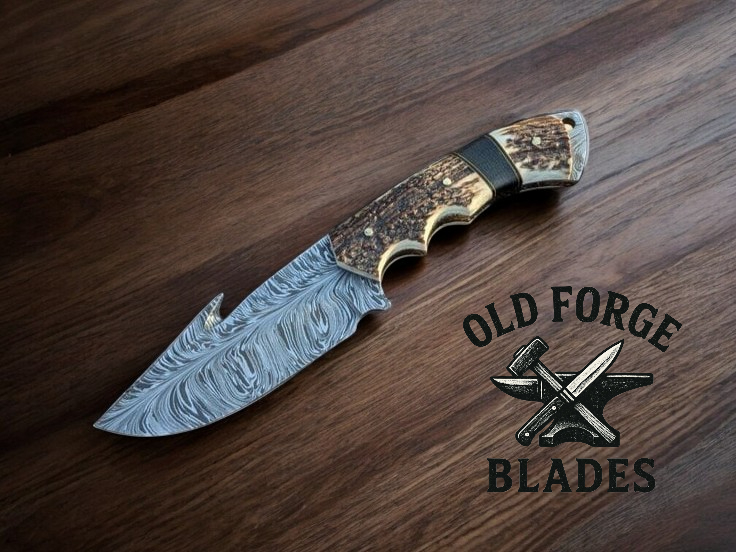 Damascus blade hunting knife with gut hook and stag antler handle