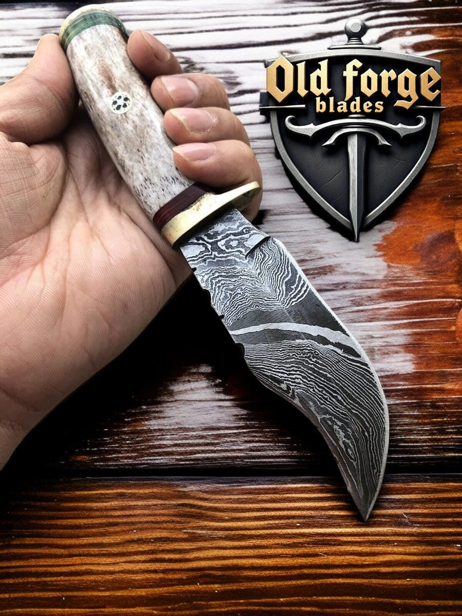 Close-up of sharp Damascus steel blade hunting knife